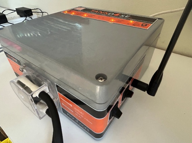 TankDose V1.1 control unit with pump attached, on the bench