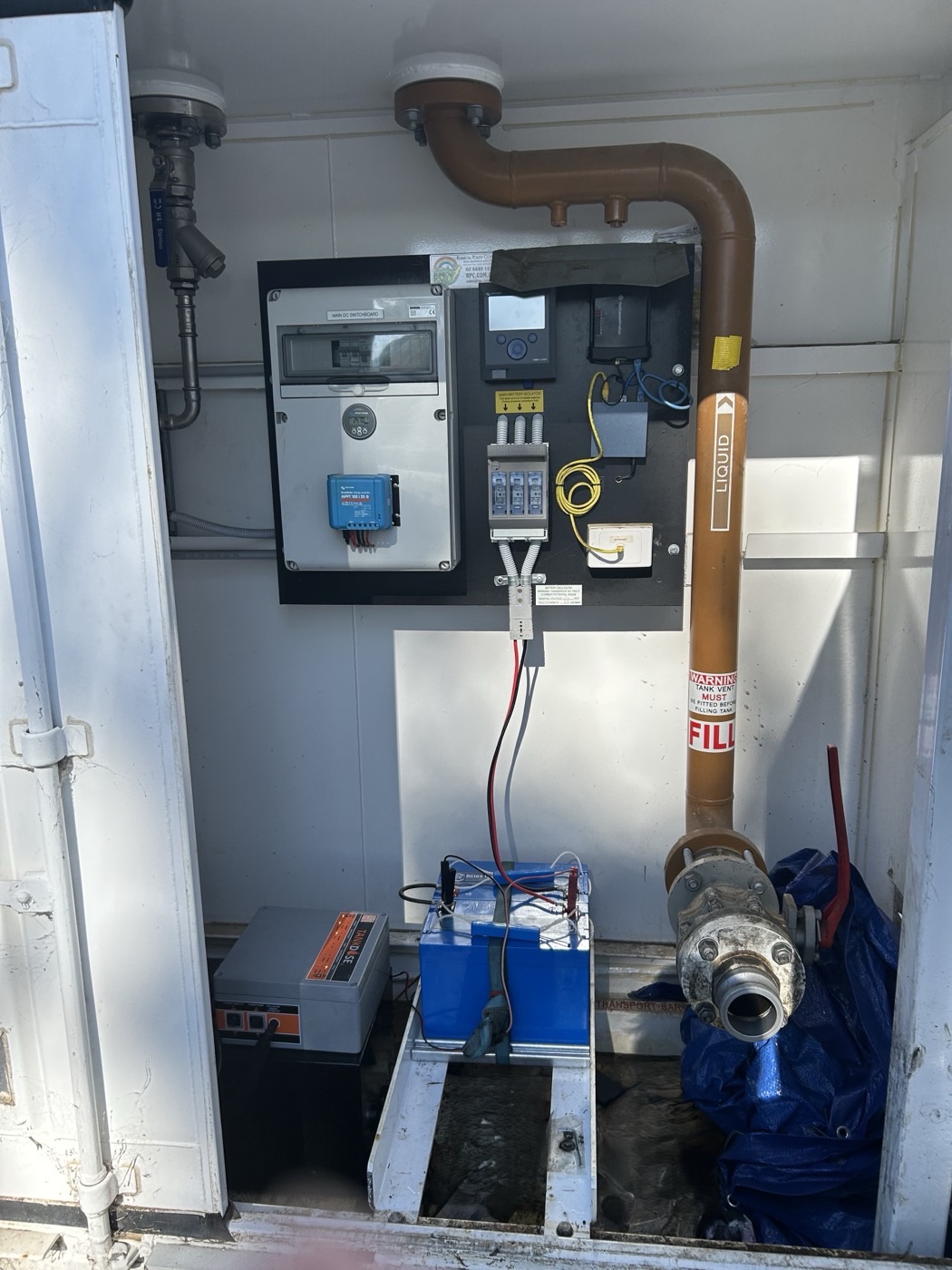 TankDose electrical and plumbing installation inside a fuel tank enclosure